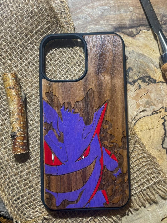 a wooden phone case with a picture of a gengar on it