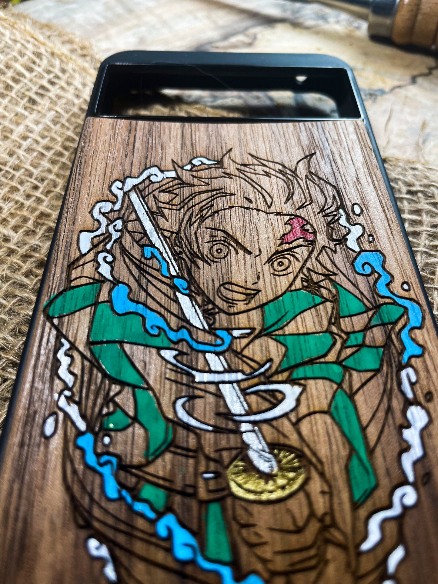 a wooden phone case with a picture of a woman holding a sword